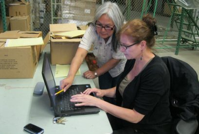 Archivists in warehouse at work on Stevens Papers Collection - 2011.