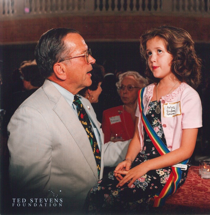 Sen. Ted Stevens greets Arlys Endres, of Phoenix, a speaker at the "Raise the Statue" event in the Capitol on July 25, 1996. Nine-year-old Endres became passionately involved in raising money to move the statue of suffrage pioneers to a place of honor in the Rotunda, where it stands today. Stevens Foundation photo.